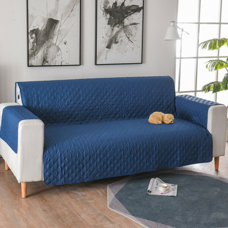 a couch with a blue cover on it in a living room